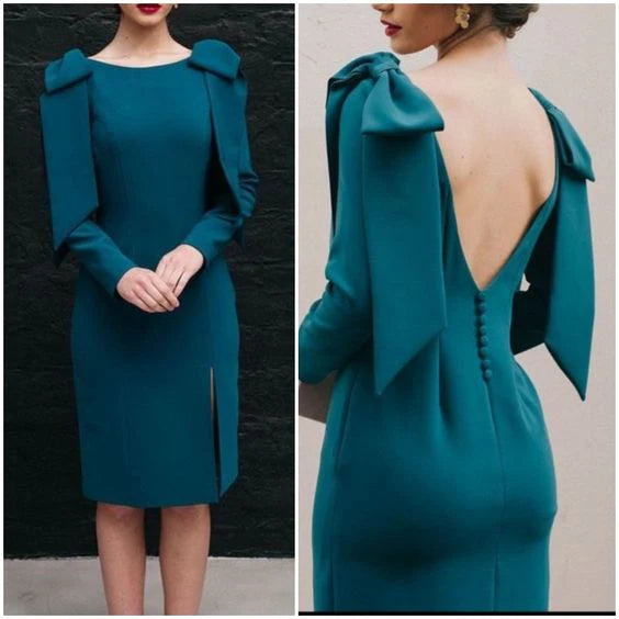 Woman wearing a dark, elegant long-sleeve mid-length minimalist evening dress.