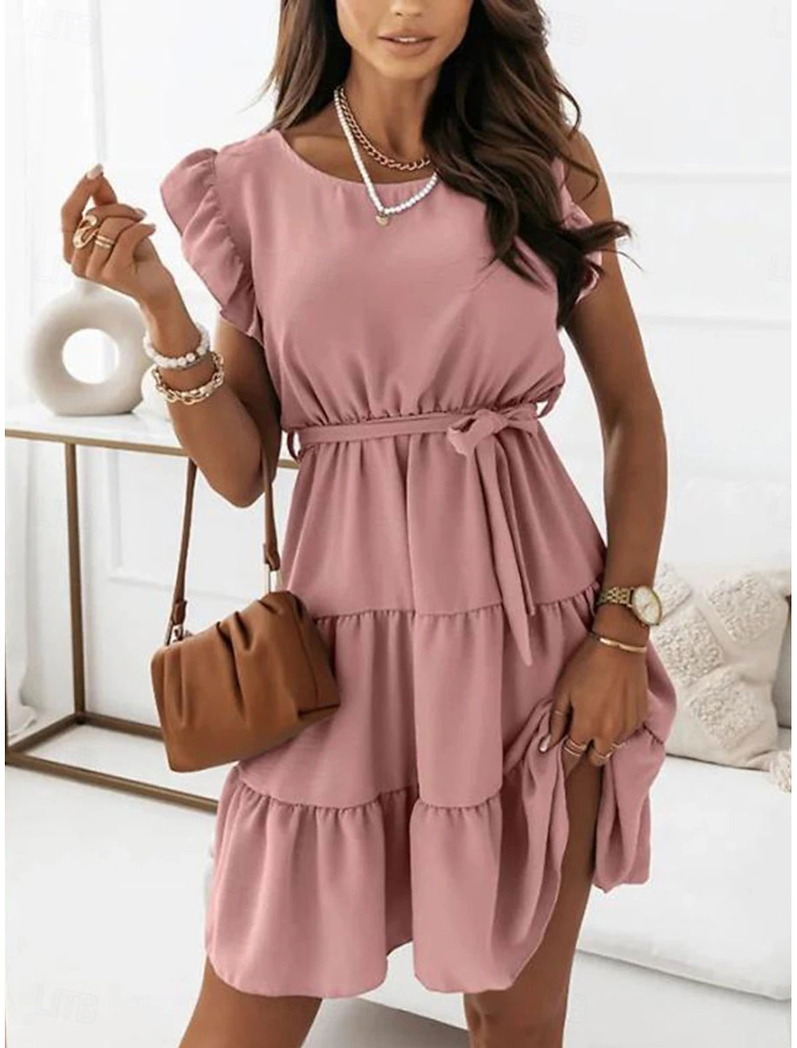 Woman modeling an elegant A-line mini dress with short sleeves and a crew neck.