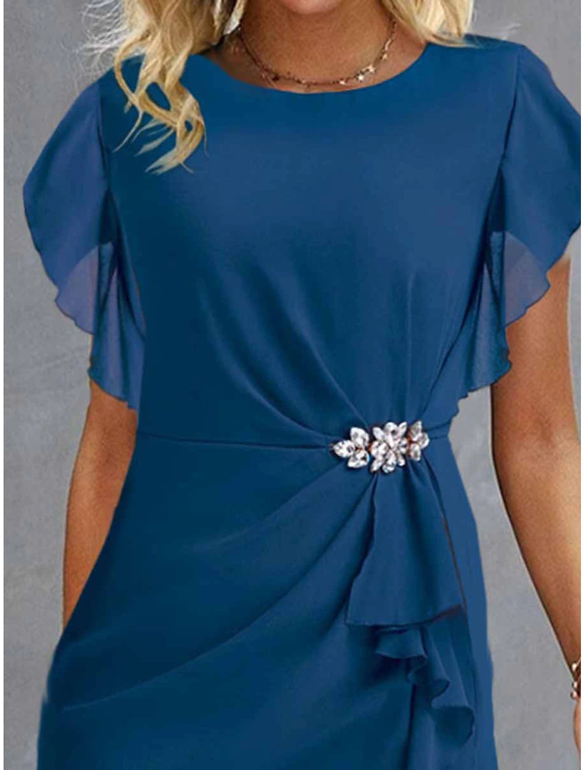 Model posing in a solid wine blue crew neck party dress.