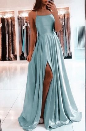Woman wearing an elegant A-line sleeveless satin ball gown.