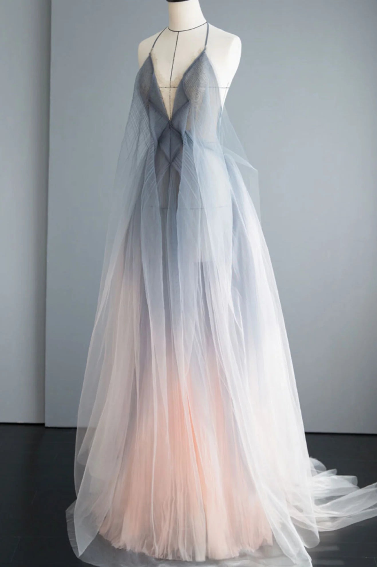Front view of an elegant gray tulle long prom dress with delicate spaghetti straps.