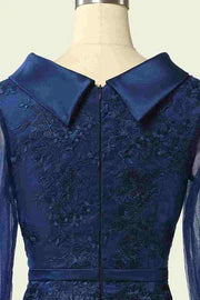 Close-up of the delicate embroidery on the bodice and the high-collar detail of the navy blue dress.