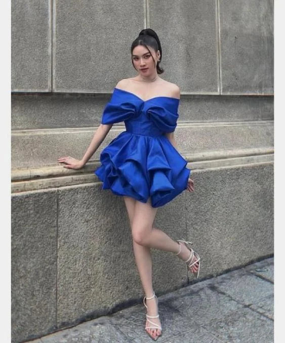 Model wearing an elegant blue off-shoulder mini homecoming dress, front view.