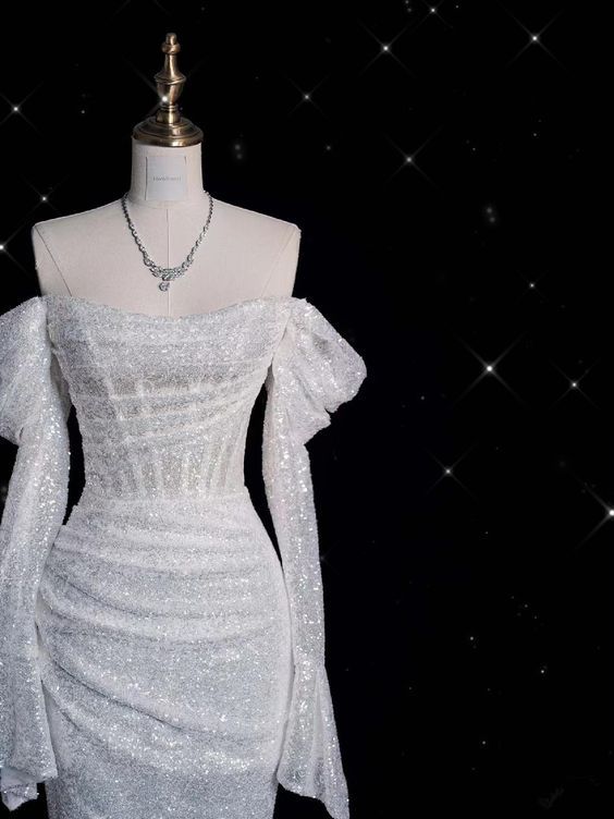 Close-up of the sparkling glitter and sequin details on the wedding dress bodice.