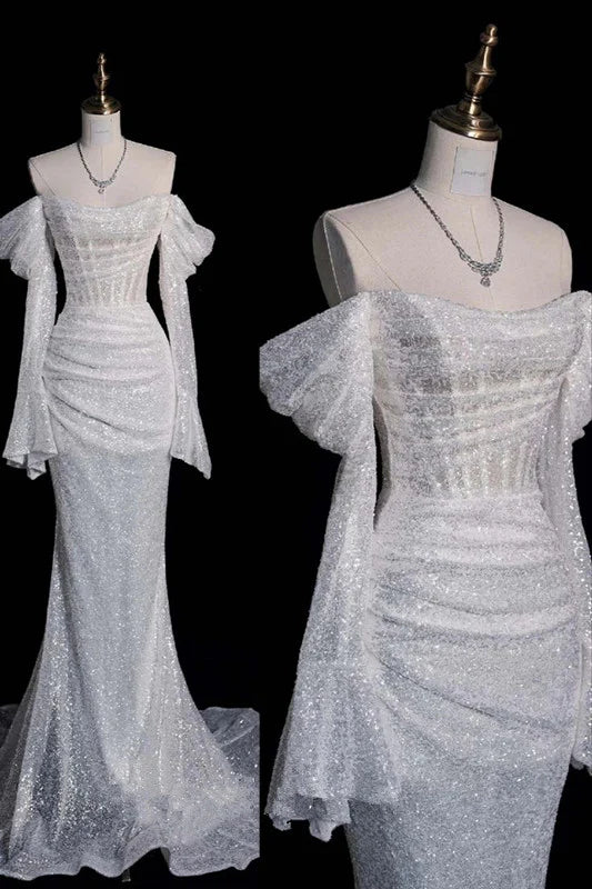 Side profile of a bride in the A-line off-shoulder wedding dress, highlighting the silhouette.