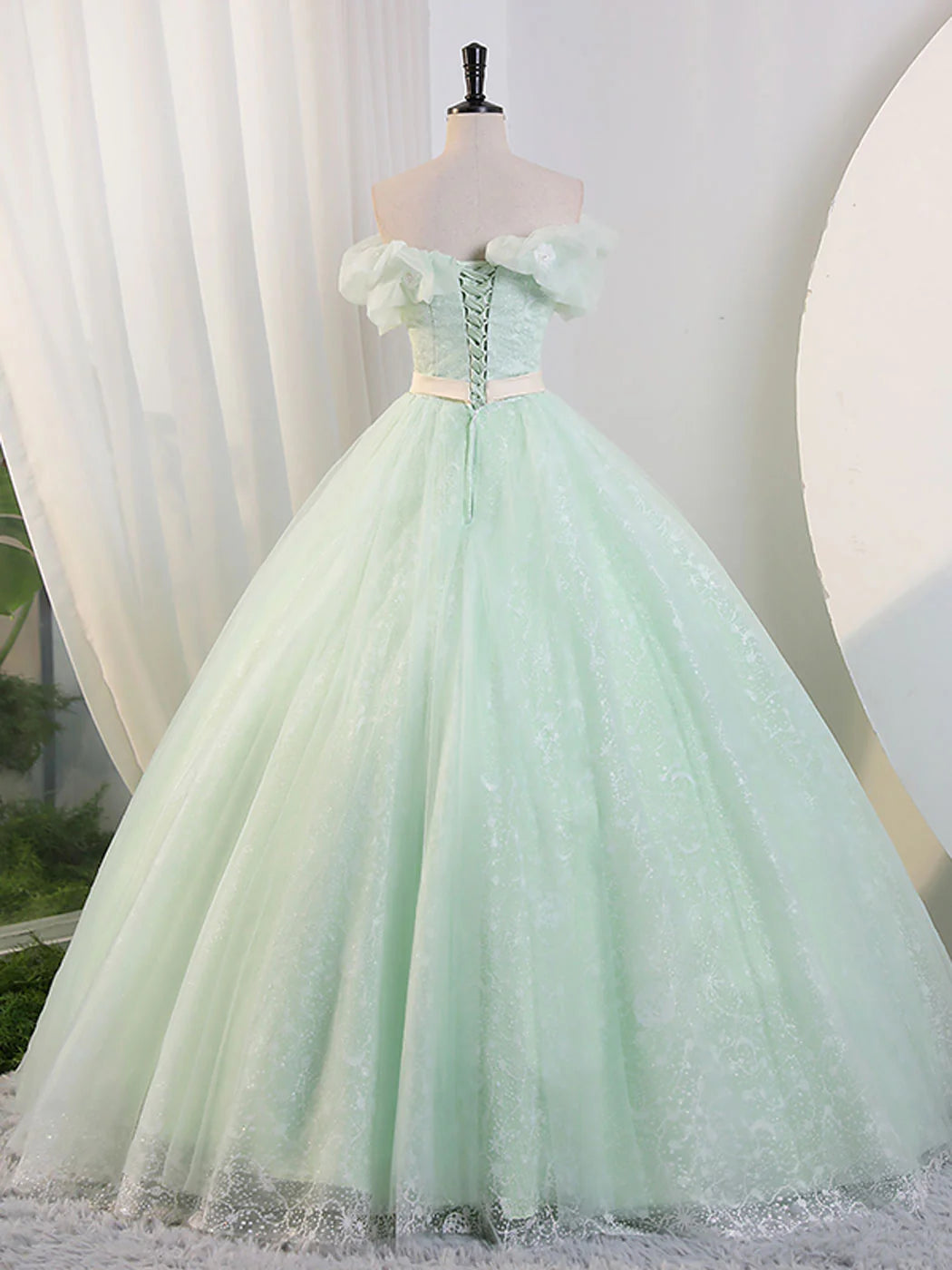 Back view of the green A-line off-shoulder formal dress.