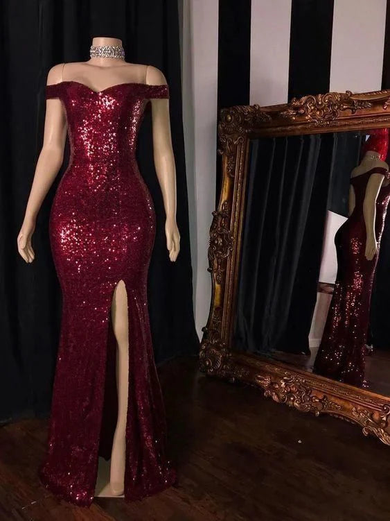 Full-length view of a woman wearing an elegant burgundy off-shoulder high-split gown.