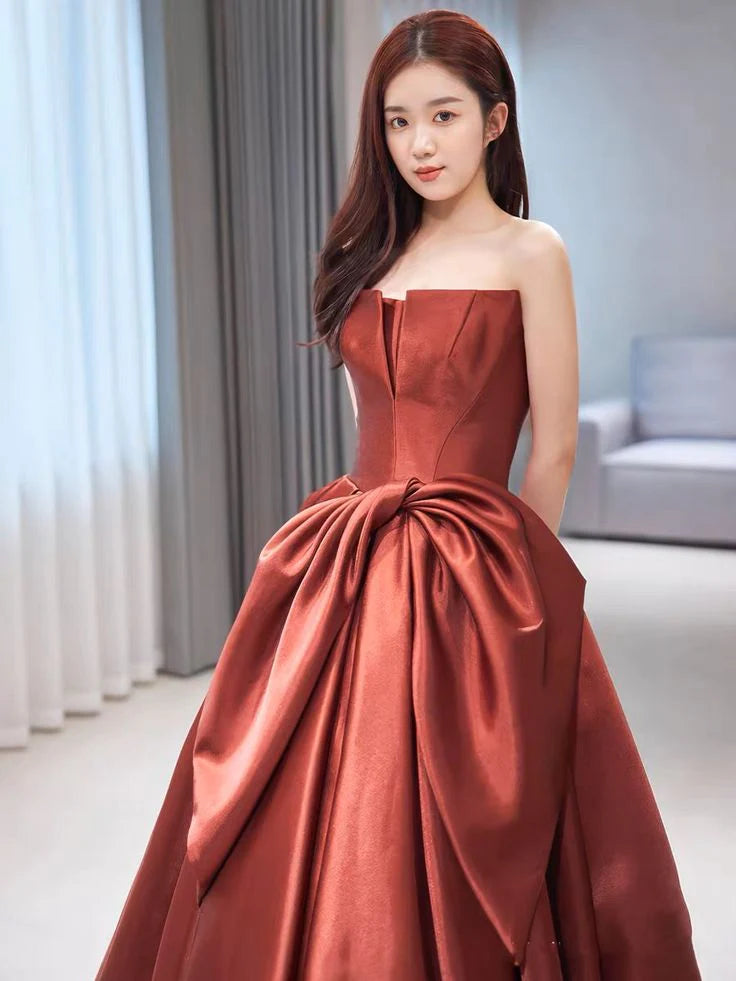 Close-up of the off-the-shoulder neckline and satin fabric of the evening dress.