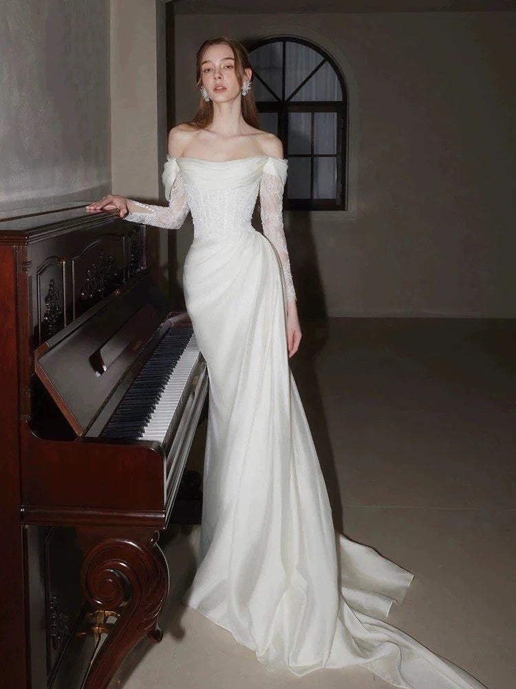 Back view of the A-line off-shoulder lace wedding dress, highlighting lace details.