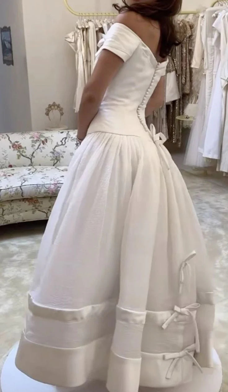 Close-up of the graceful A-line off-shoulder bridal gown.