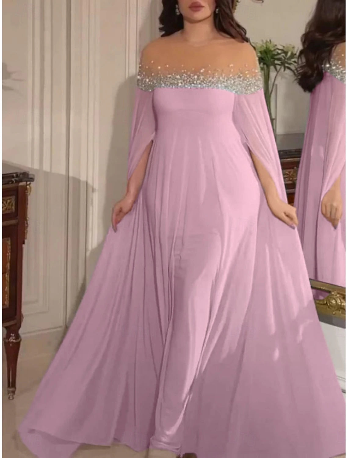 Woman walking in a vibrant pink A-line off-shoulder maxi dress.