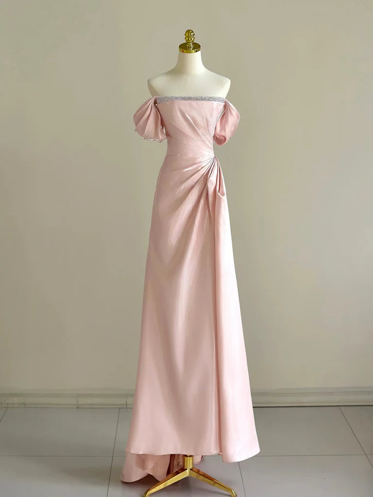 Model wearing an elegant A-line off-shoulder pink long prom dress with beaded details.