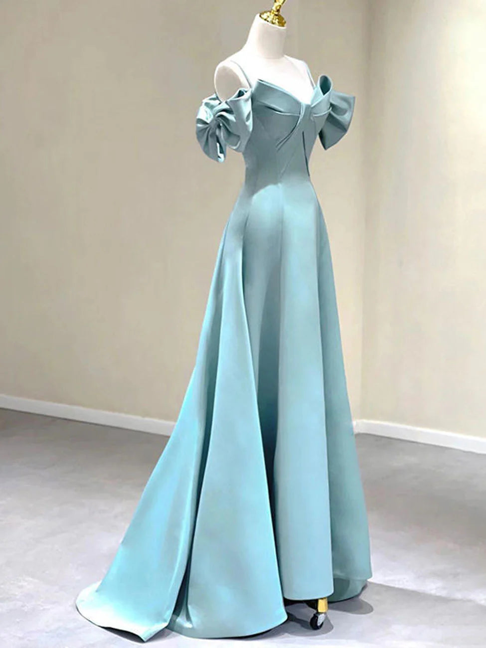 Side view of a blue A-line off-shoulder satin long prom dress.