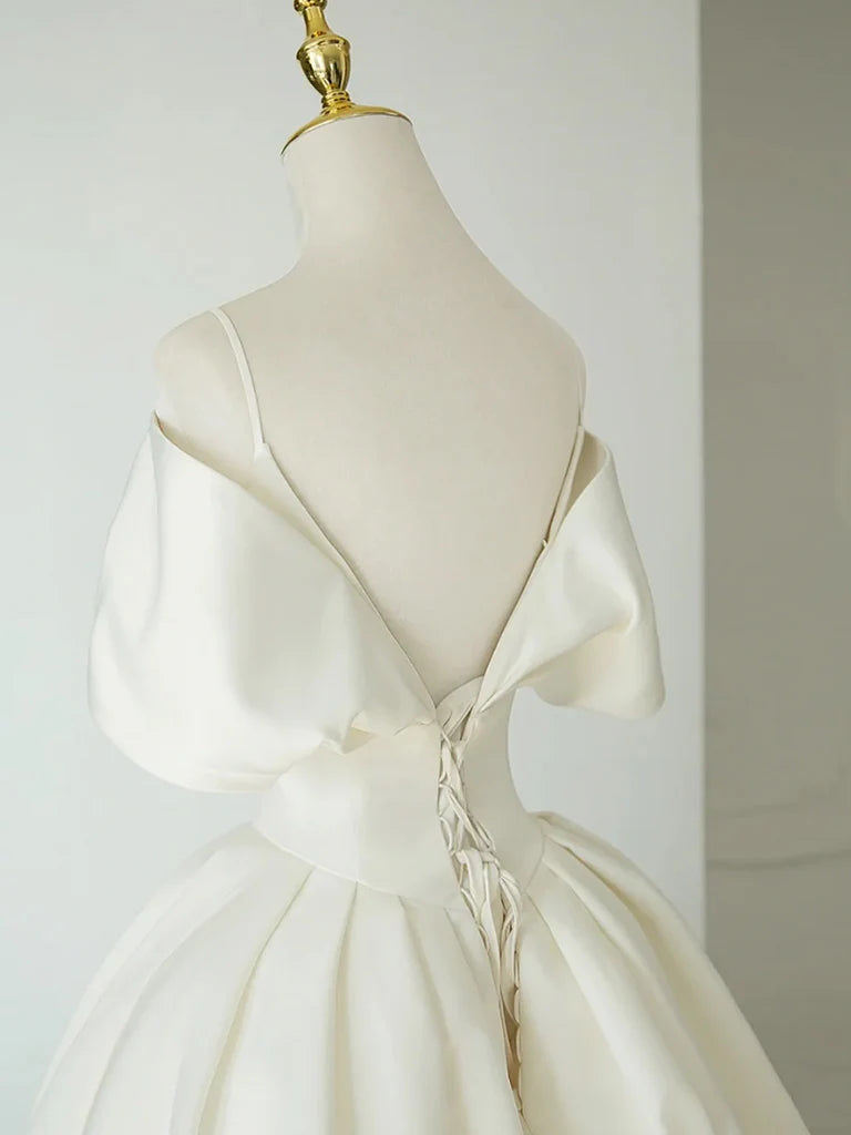Side view of a model in an ivory A-Line off-shoulder satin gown, showcasing the flowing skirt.