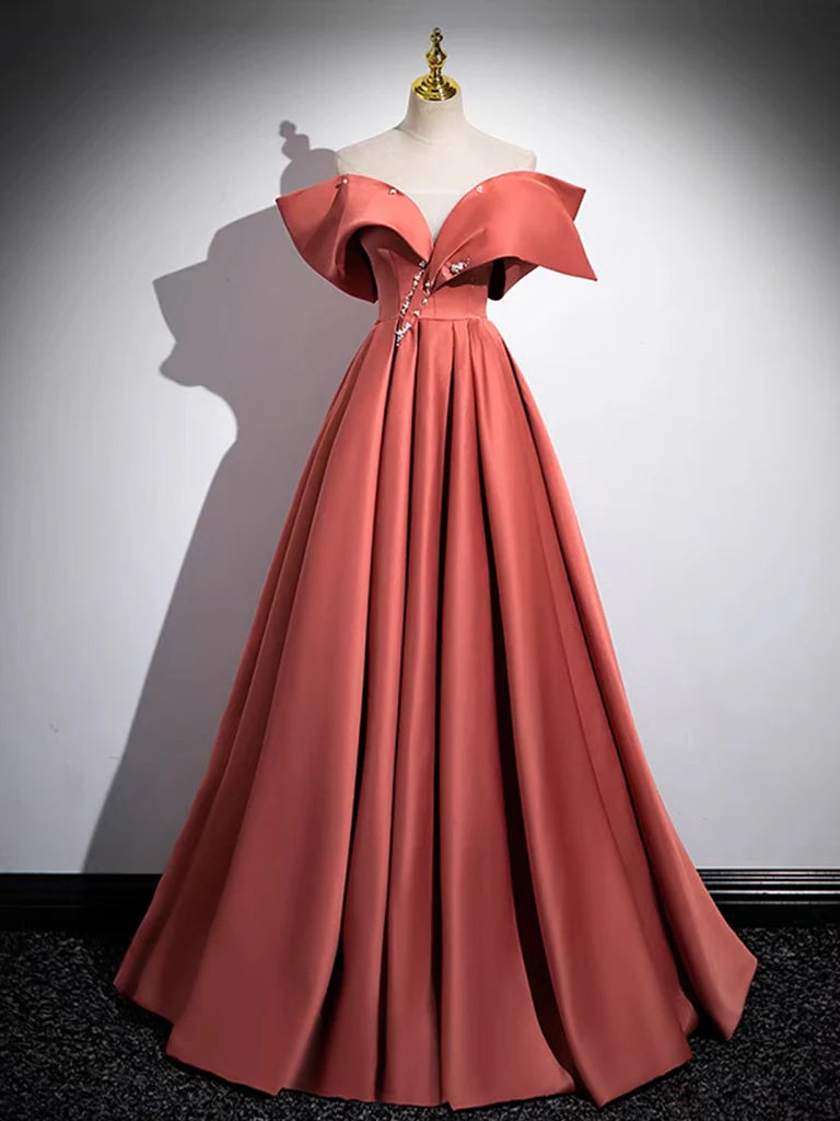 A woman wearing a watermelon red A-line off-shoulder satin long prom dress, posing elegantly.