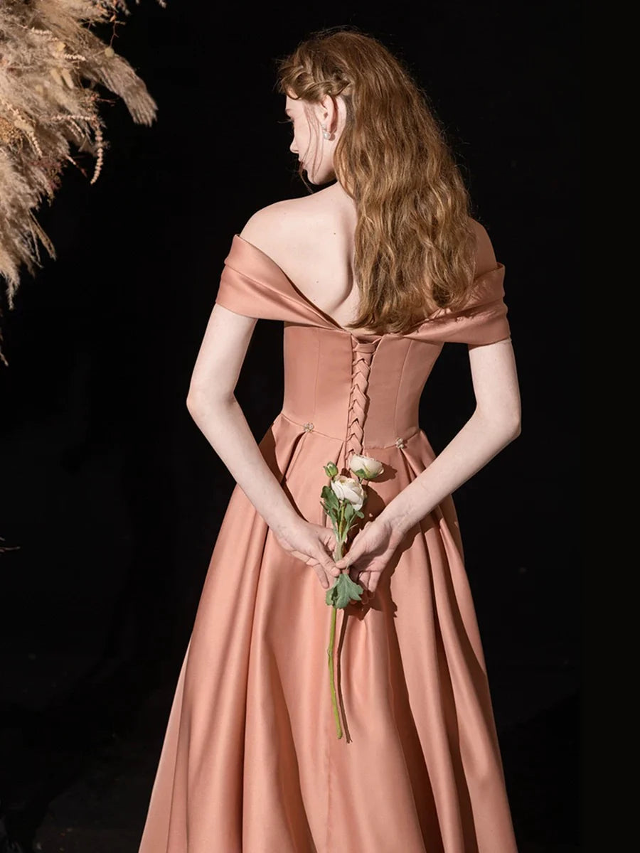 Side view of a woman wearing the pink A-line formal dress.