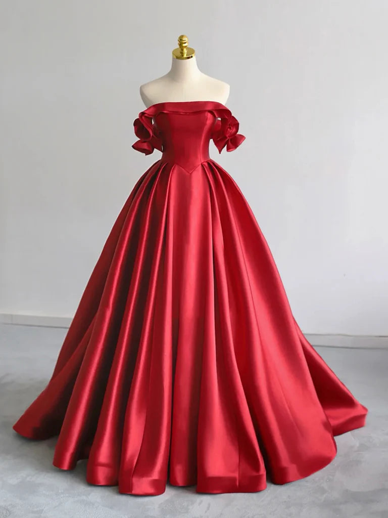 Woman wearing an elegant A-line off-shoulder red satin long prom dress.