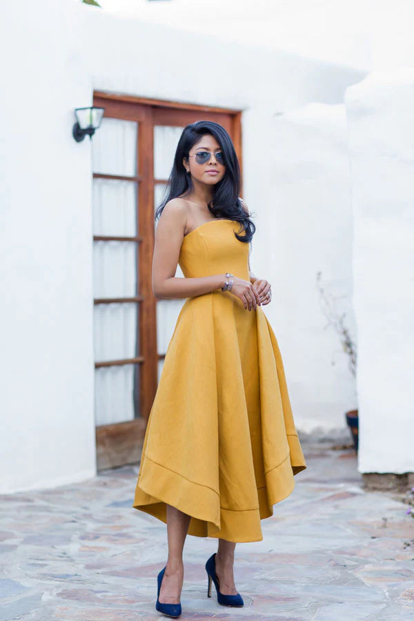 Model wearing an elegant yellow off-shoulder short satin prom dress, front view.