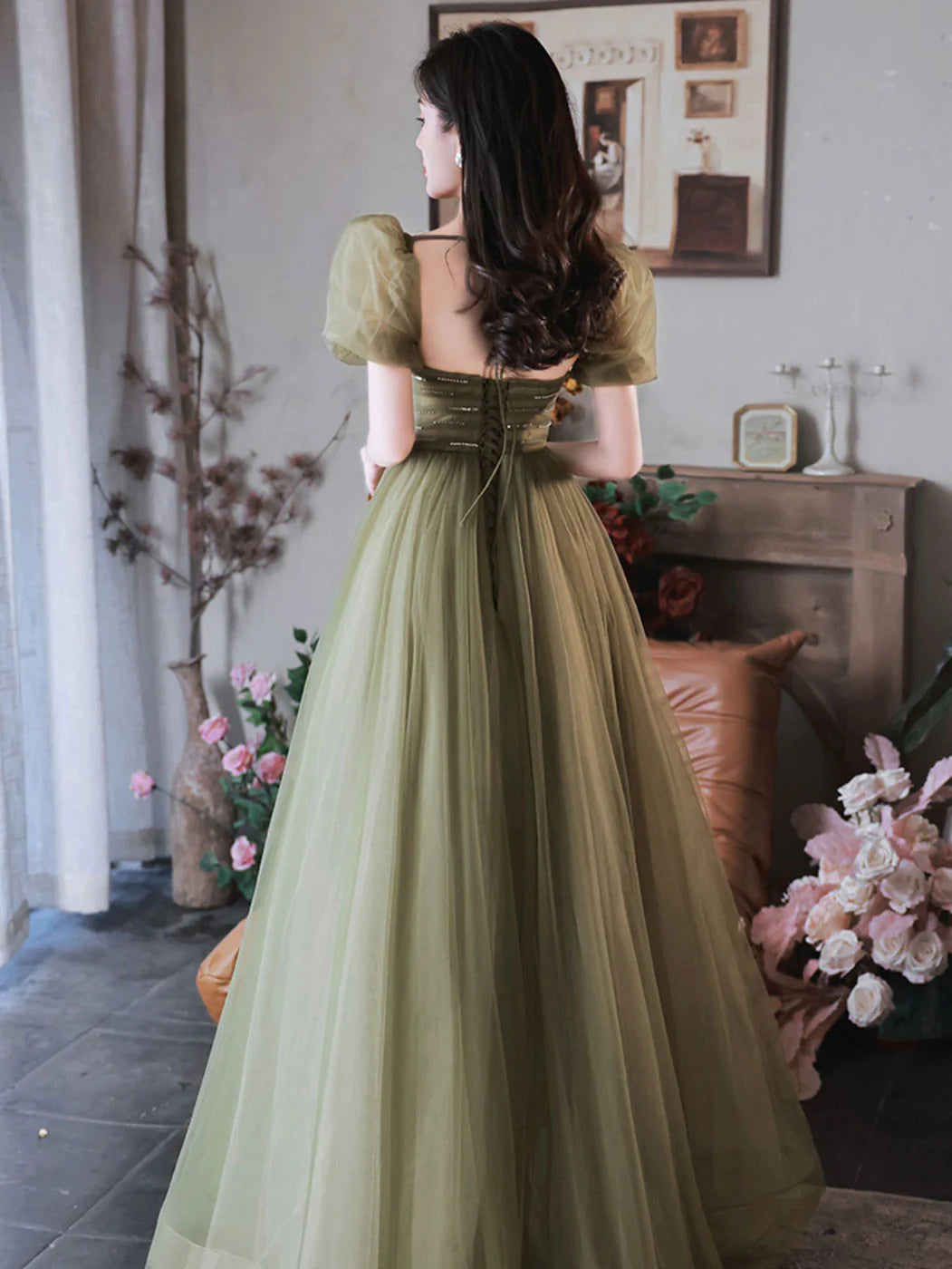 Close-up of the A-line green sequin tulle off-shoulder long prom dress, showcasing the fabric detail.