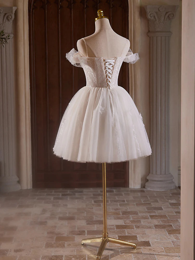 Model posing in a light champagne off-shoulder sweetheart neck tulle lace homecoming dress.