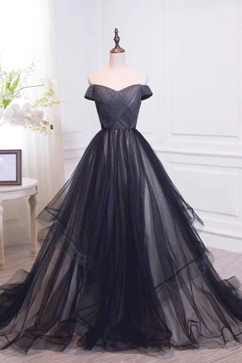 Model wearing a black off-shoulder tulle long prom dress, front view.