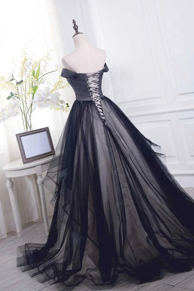 Model wearing a black off-shoulder tulle long prom dress, side view.