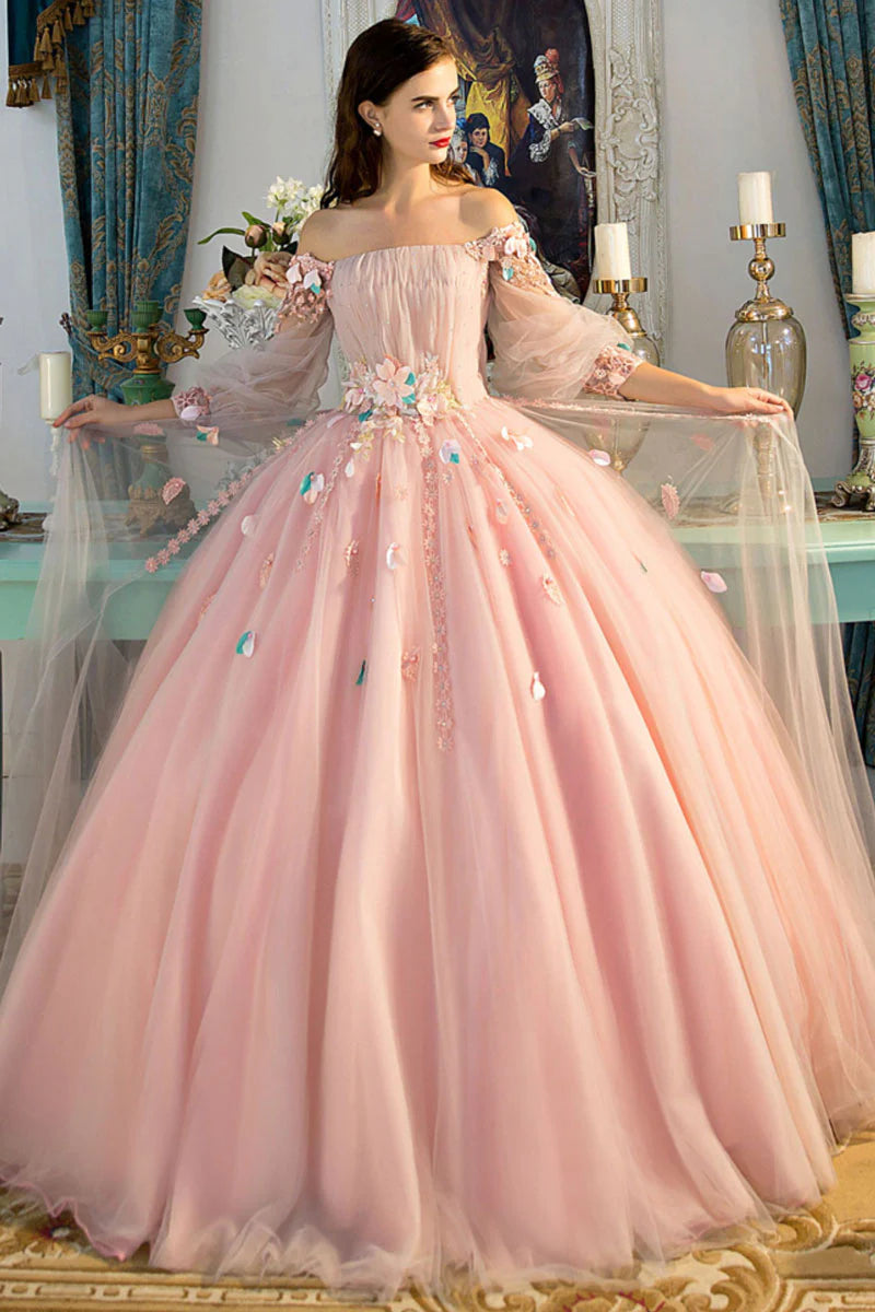Model posing in a pink off-shoulder A-line tulle gown.