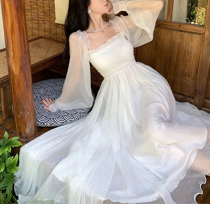 Close-up of the off-the-shoulder neckline and bodice of the white evening dress.