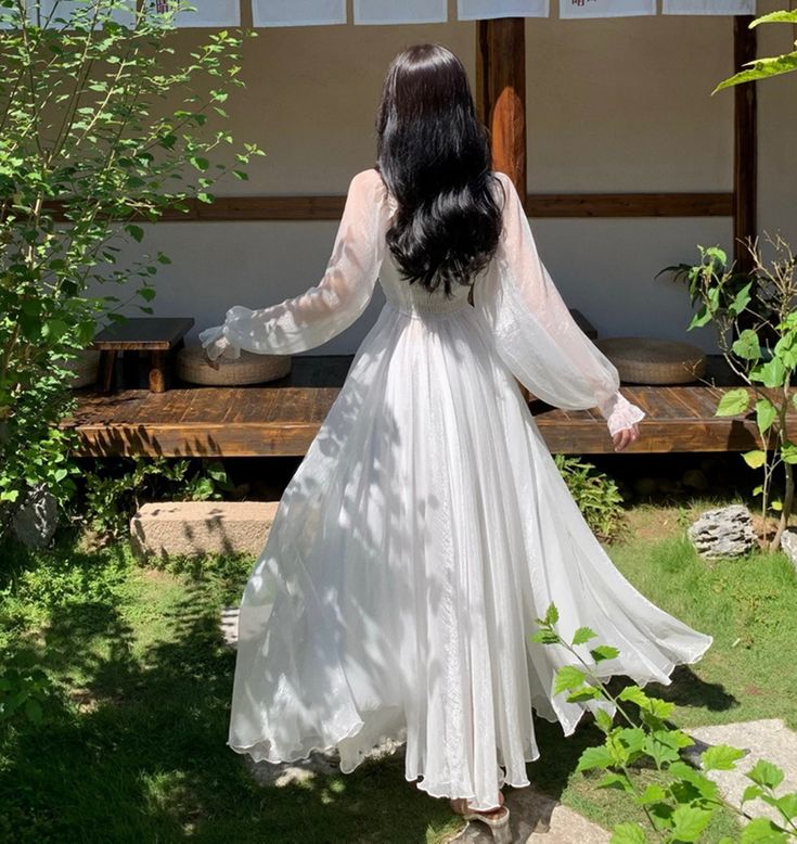 Back view of the elegant white A-line off-shoulder formal dress.