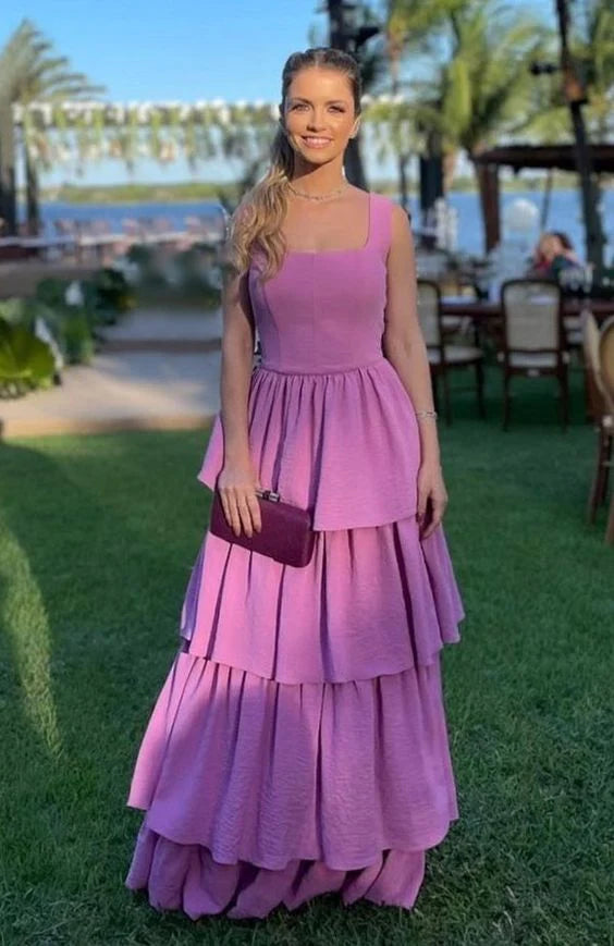 Woman wearing an elegant A-line off-the-shoulder purple chiffon ball gown.