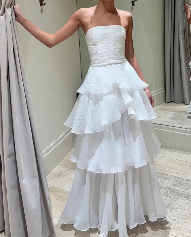 Detail of the multi-layer skirt and off-the-shoulder neckline on the white ball gown.