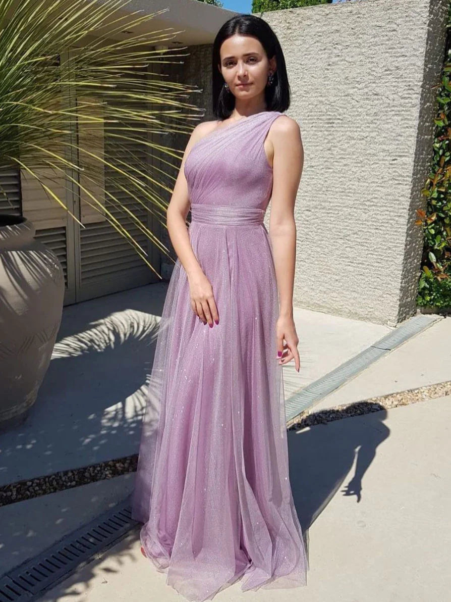 Woman wearing an elegant purple one-shoulder long tulle prom dress.