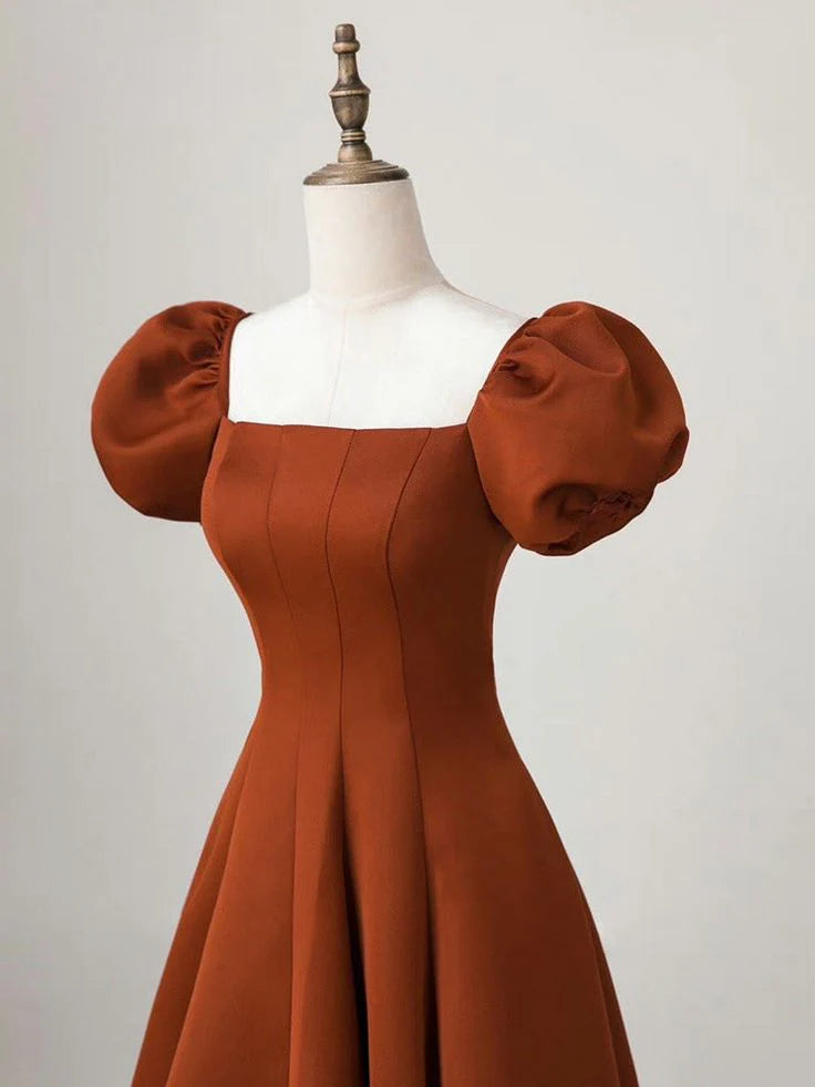 Back view of the elegant long satin gown with puff sleeves and a modest train.