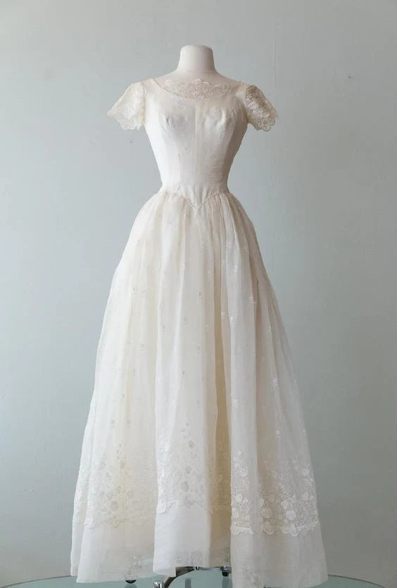 Elegant ivory short sleeve A-line prom dress on a model, front view.