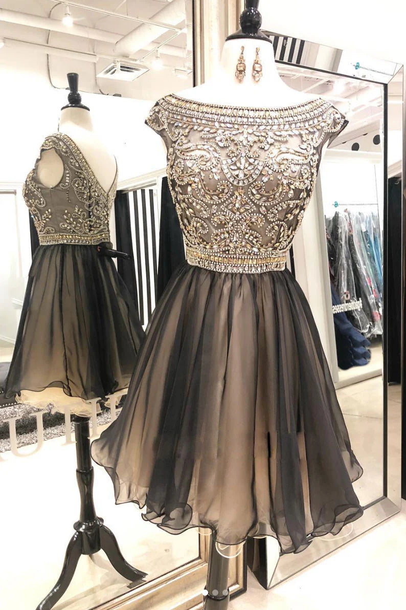 Model wearing an elegant short round neck beaded tulle prom dress.