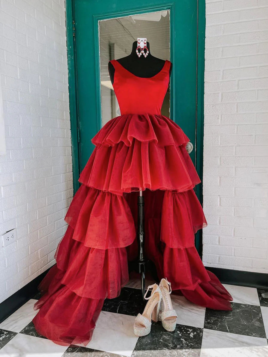 Woman wearing an elegant burgundy high-low tulle prom dress with a round neck.