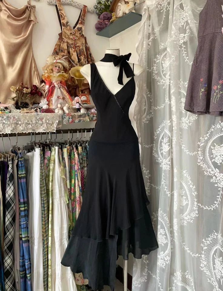 Woman wearing an elegant black A-line ruffle V-neck floor-length formal prom dress.
