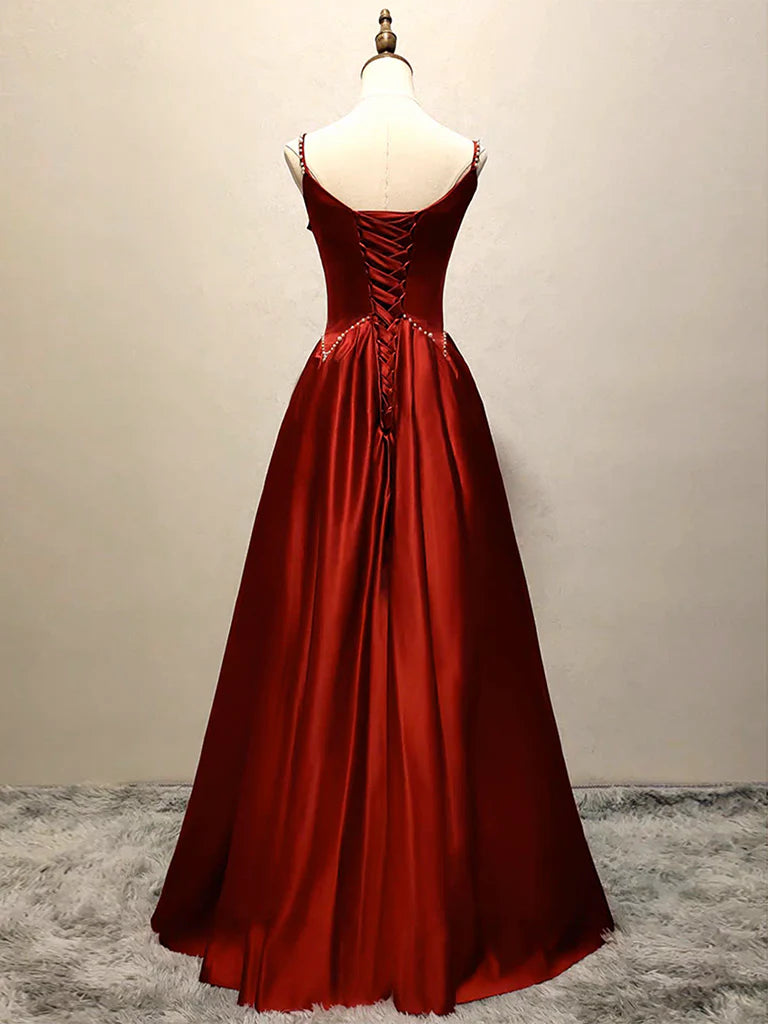Back view of a model showcasing an A-line satin burgundy long evening gown.