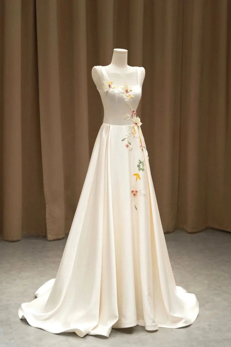 Side view of light champagne satin formal dress with delicate 3D floral details.