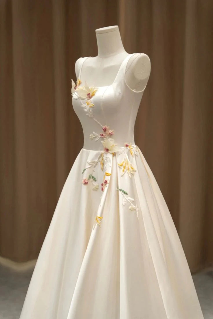 Back view of floor-length A-line evening gown in light champagne satin.