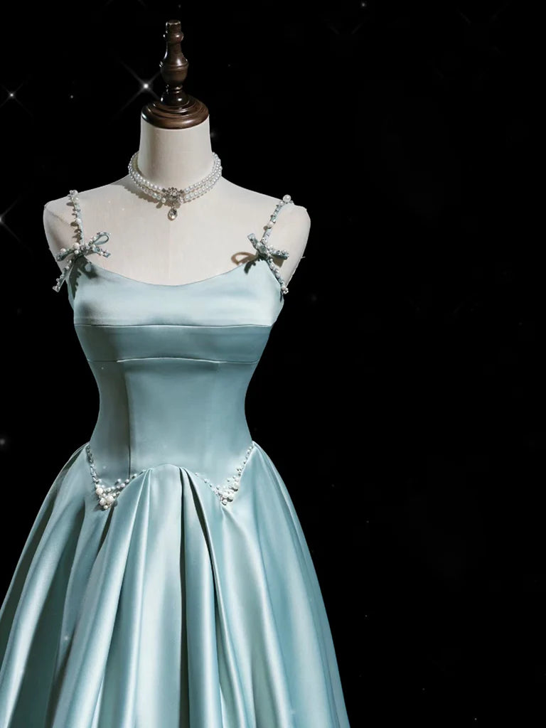 Model in a flowing blue satin A-line formal dress, side view.