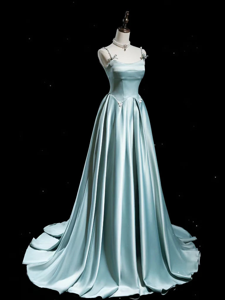 Back view of a woman wearing a long blue satin evening gown.