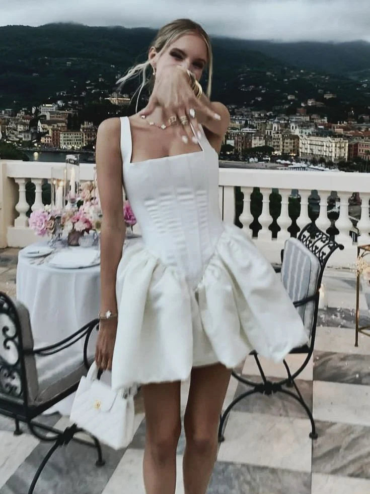 Model wearing a white A-line satin short party dress with a sleeveless design.