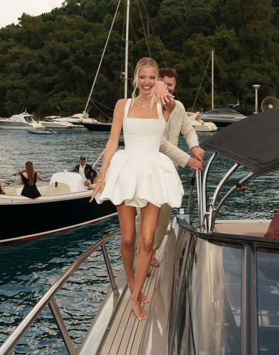 Close-up of the white A-line satin short party dress, highlighting the exquisite tailoring.