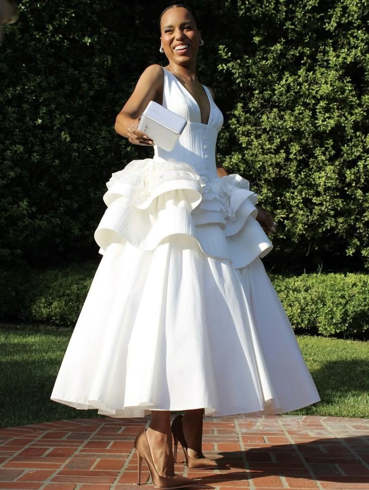 Woman wearing a white A-line satin ankle-length evening dress.