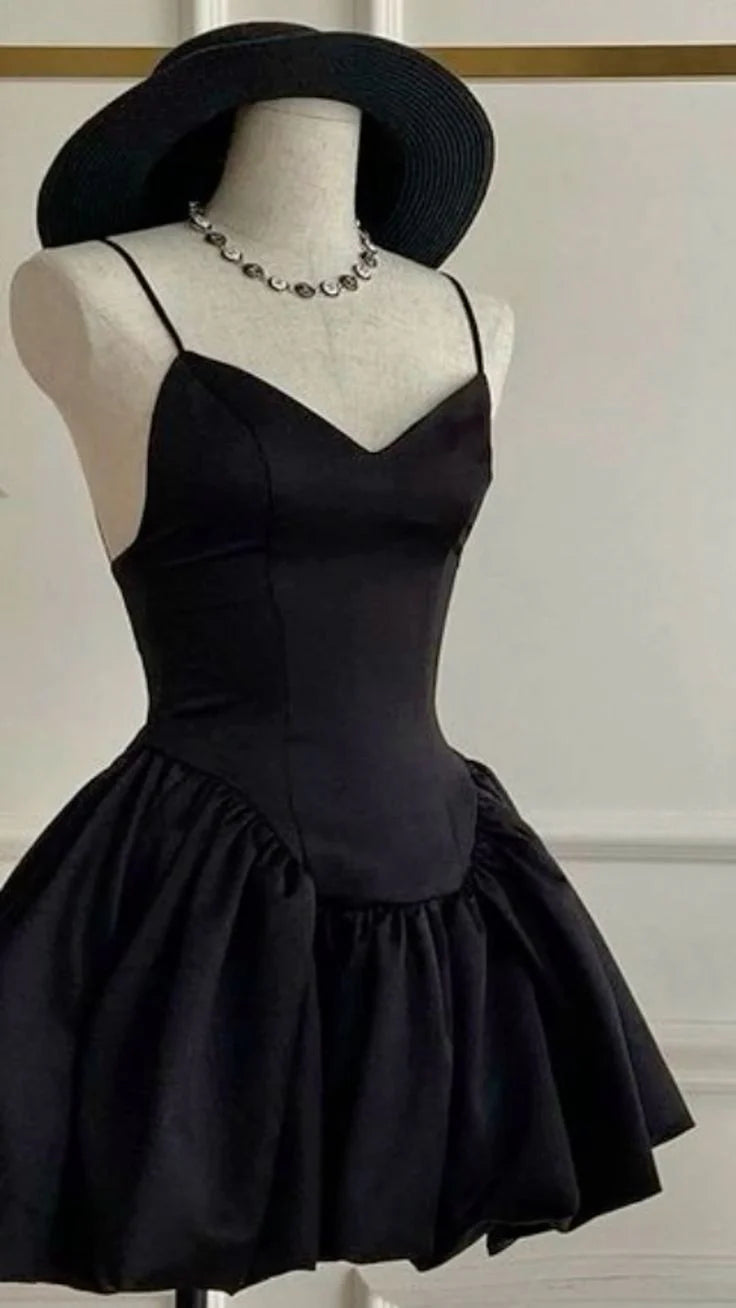 Woman wearing an elegant A-line short party dress with delicate satin straps.
