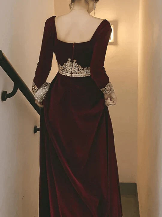 Back view of a formal A-Line velvet gown with intricate appliques.