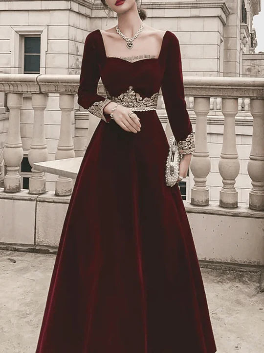 Side profile of a woman wearing a luxurious velvet evening dress.