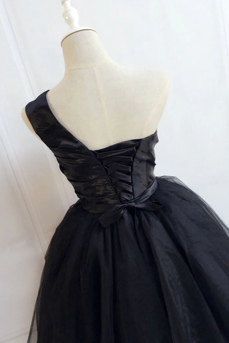 Back view of a model in a short black homecoming dress.