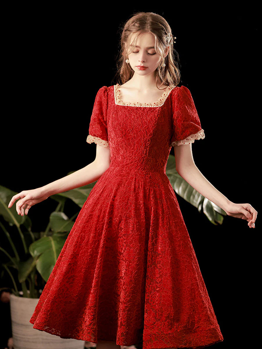 Model wearing a burgundy lace short A-line prom dress.